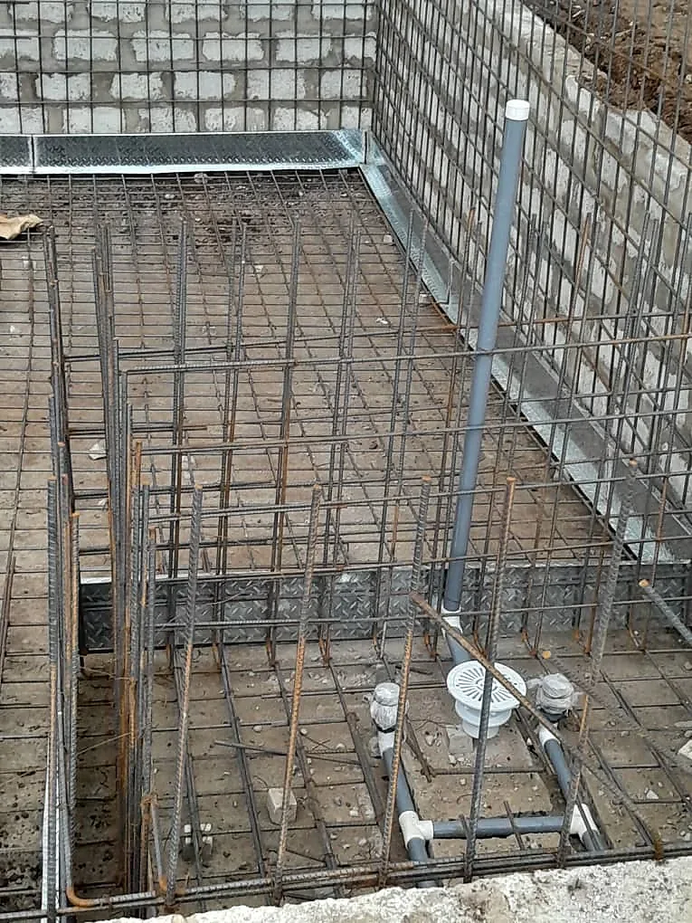 Steel reinforcement and waste pipework fixed and set out before the pour.