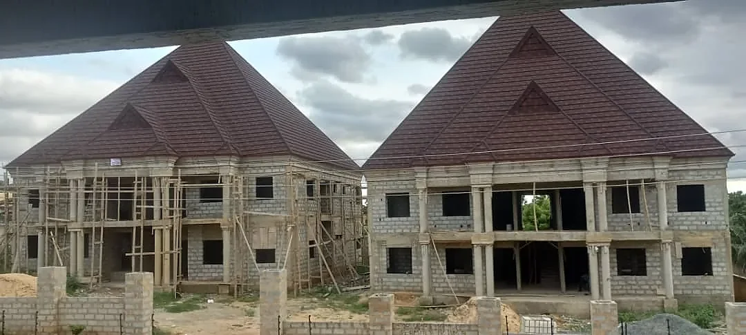 The same blocks under construction: blockwork, columns and scaffolding with the roofs already on.