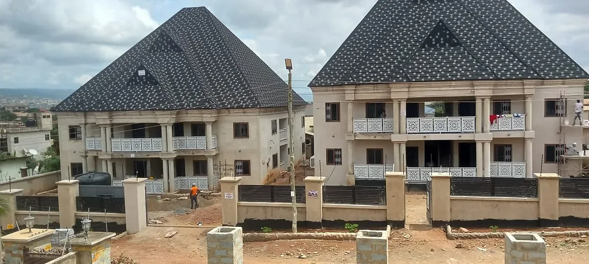 The same pair of blocks rendered, with shingle roofs on and balcony panels fitted.