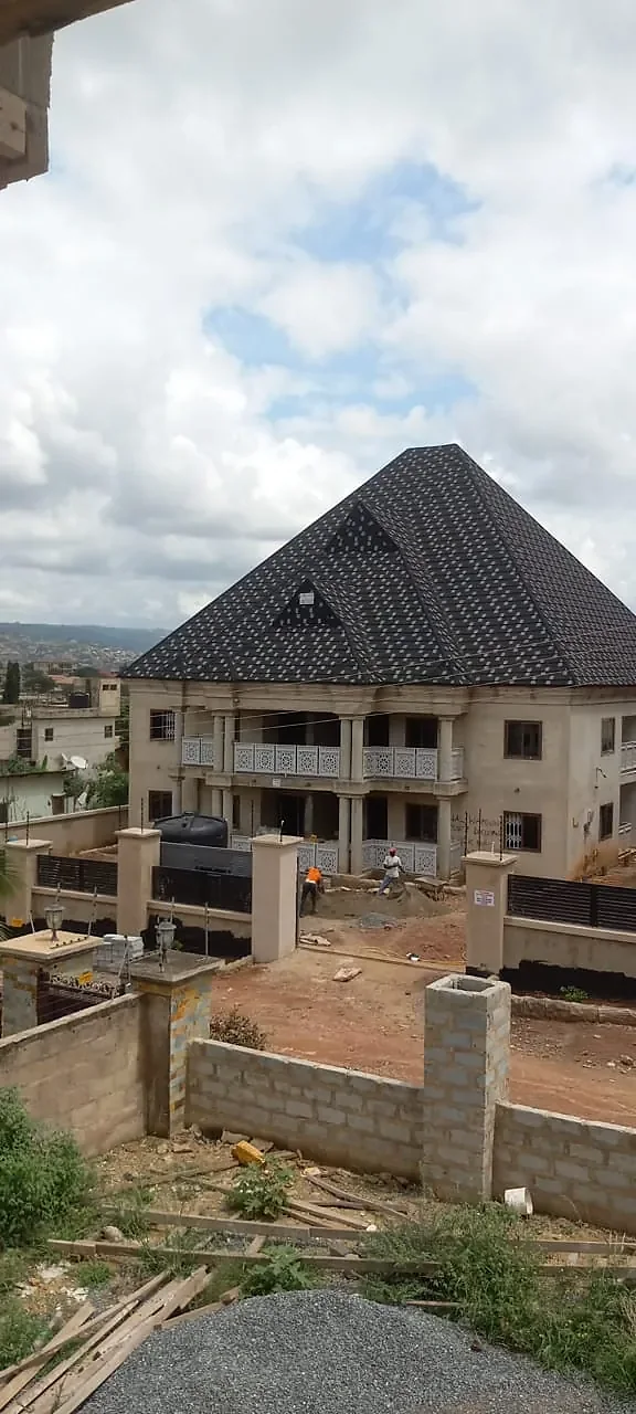 One of the blocks during the works, rendered and roofed, with the boundary wall going up.